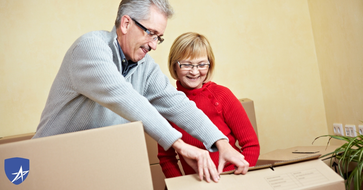 senior couple packing up to move