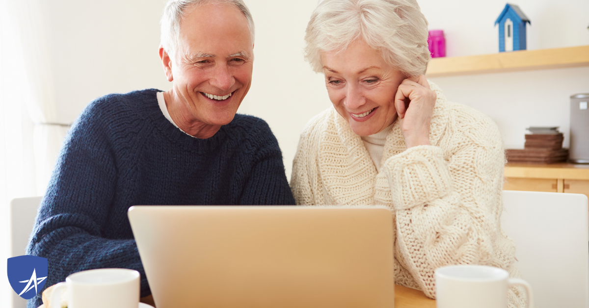 senior couple smiling at computer